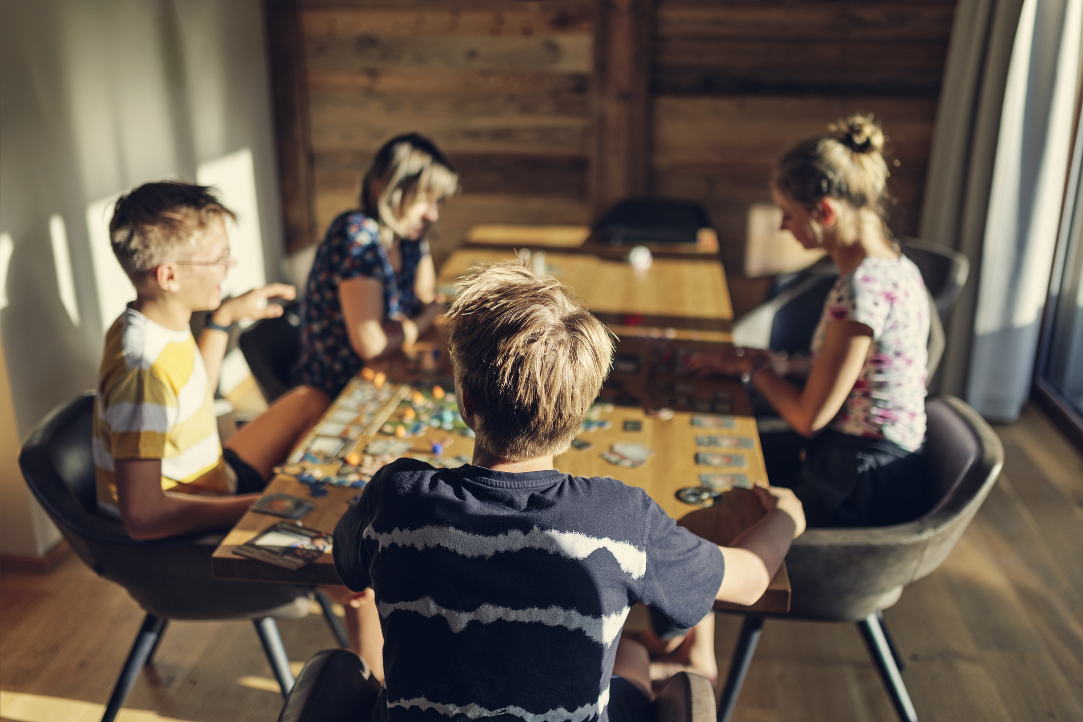 Children and parent playing board games